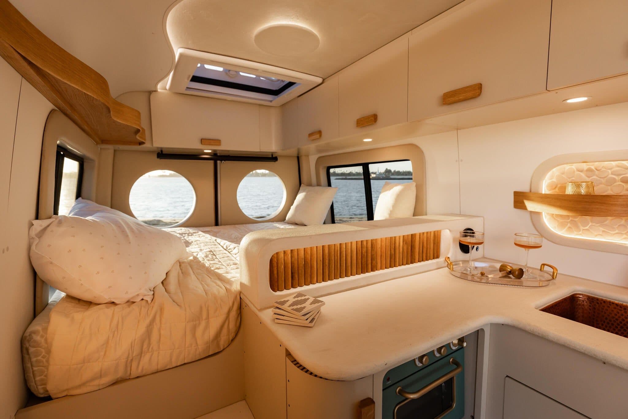 Luna bedroom — bed, galley, and portholes overlooking water.